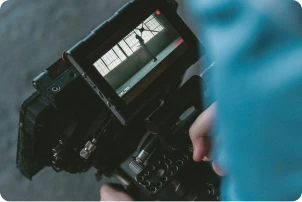 Person i blue shirt looking at a camera display