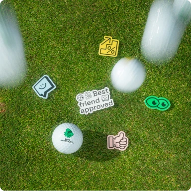 Golf balls falling on grass over Qase stickers.
