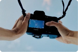 Hands holding a camera.