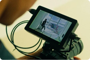 Man with beard looking at a video camera display
