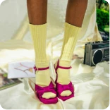 Feet in knee socks and red high heels.